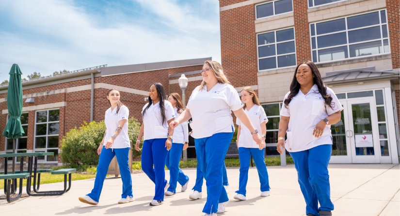 A group of students walking in front of a campus building
