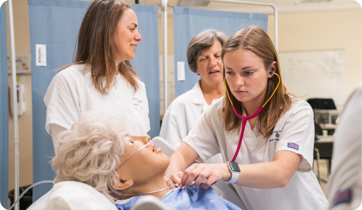 Students working with a medical mannequin