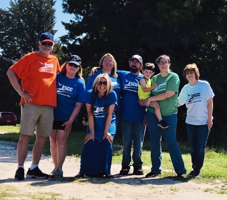 Group of students standing outside on a gravel path