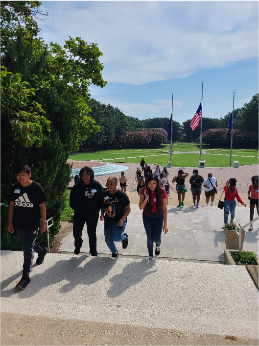 Students walking up an outside set of stairs.