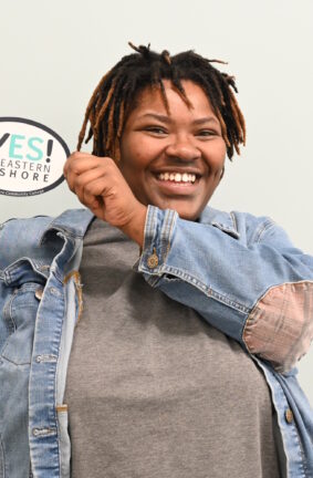 A person holding a YES Eastern Shore emblem