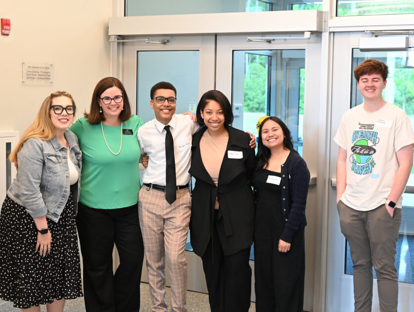 A group of people standing in front of doors leading out of the building