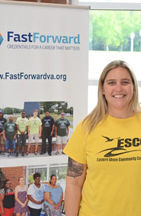 A woman standing in front of a banner about Fast Forward
