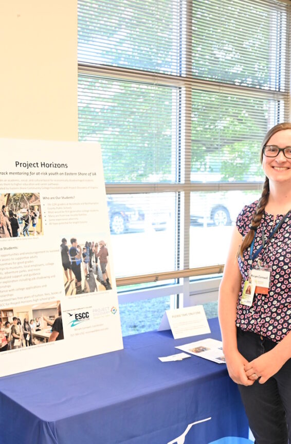 Two people standing in front of a table featuring Project Horizons