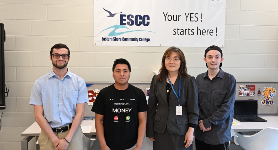 Four people standing in front of a Contact to Career sign