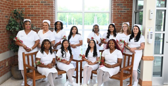 A group of women in nursing uniforms standing and seated