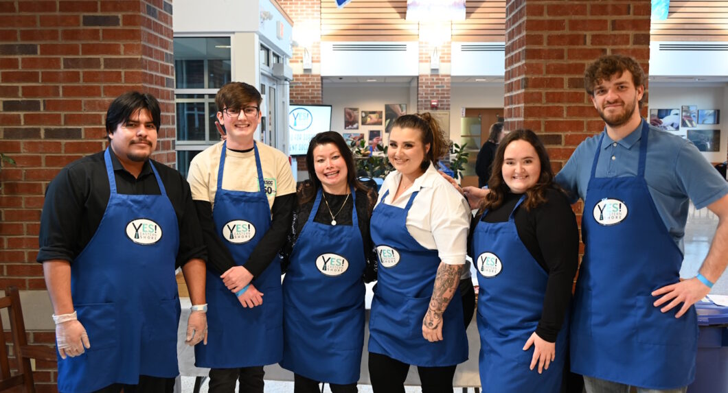 A group of people wearing blue aprons with 