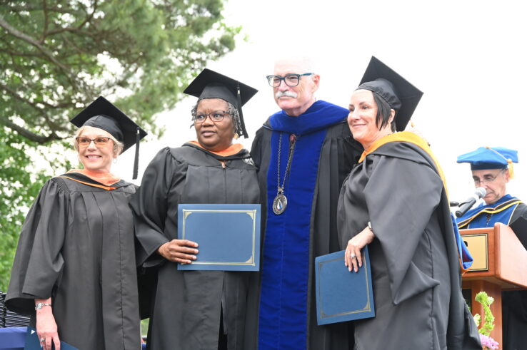 A group of people wearing caps and gowns.