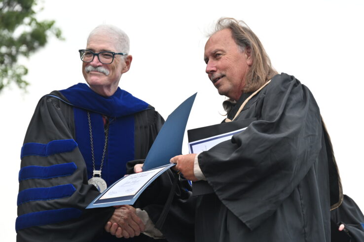 A graduate receiving his diploma from Dr. Schaeffer.