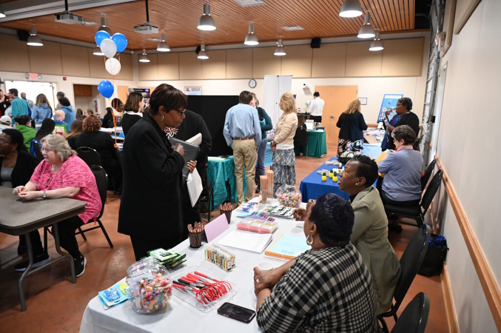 People gathered at tables in a conference room