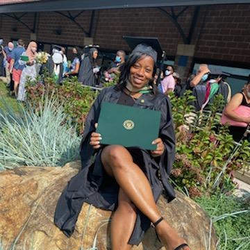 A female graduate holding her diploma