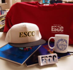 Some ESCC swag including a baseball cap, sweater and mug