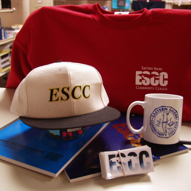 Some ESCC swag including a baseball cap, sweater and mug