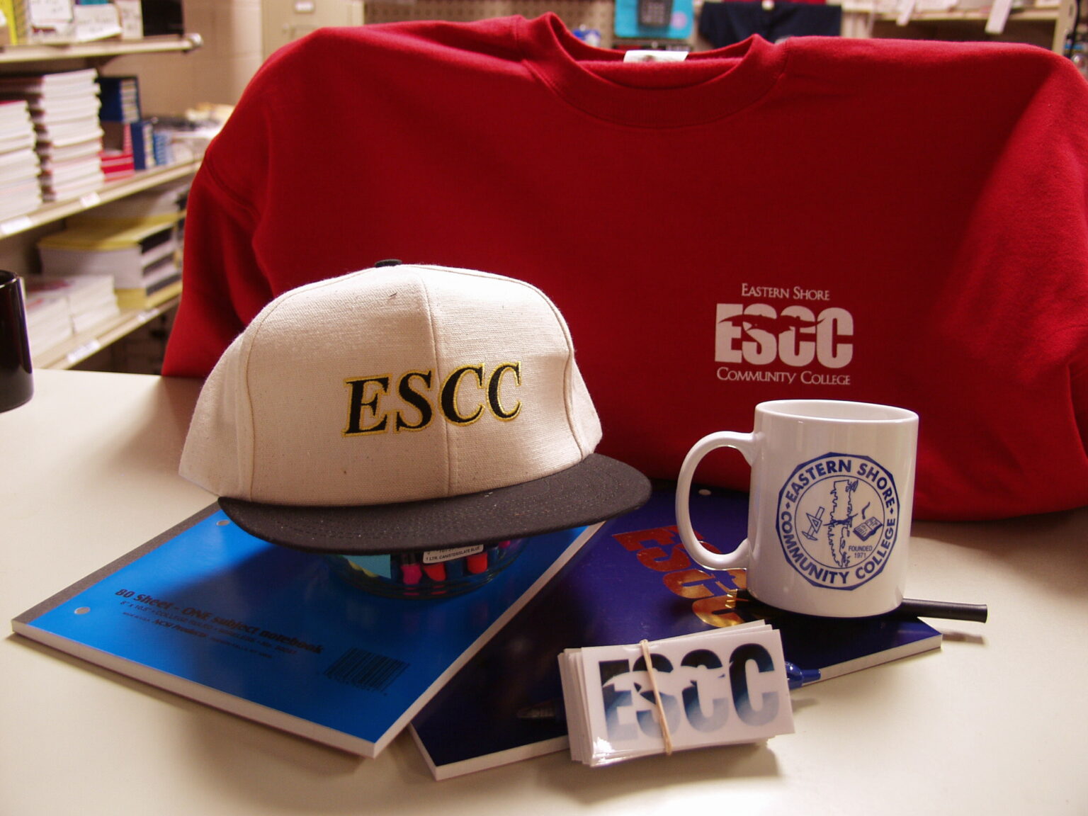 Some ESCC swag including a baseball cap, sweater and mug