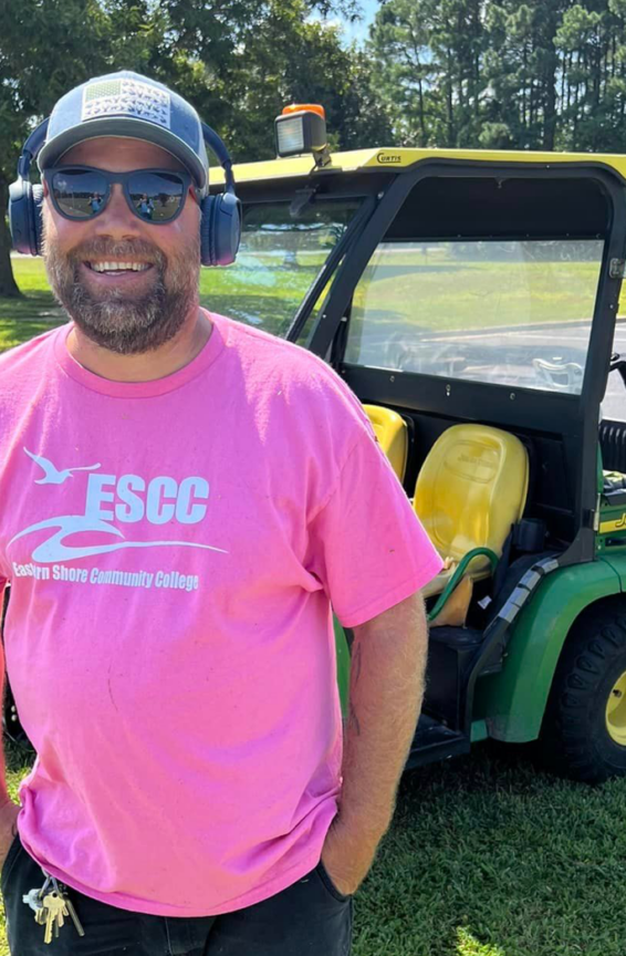 man standing in front of gator