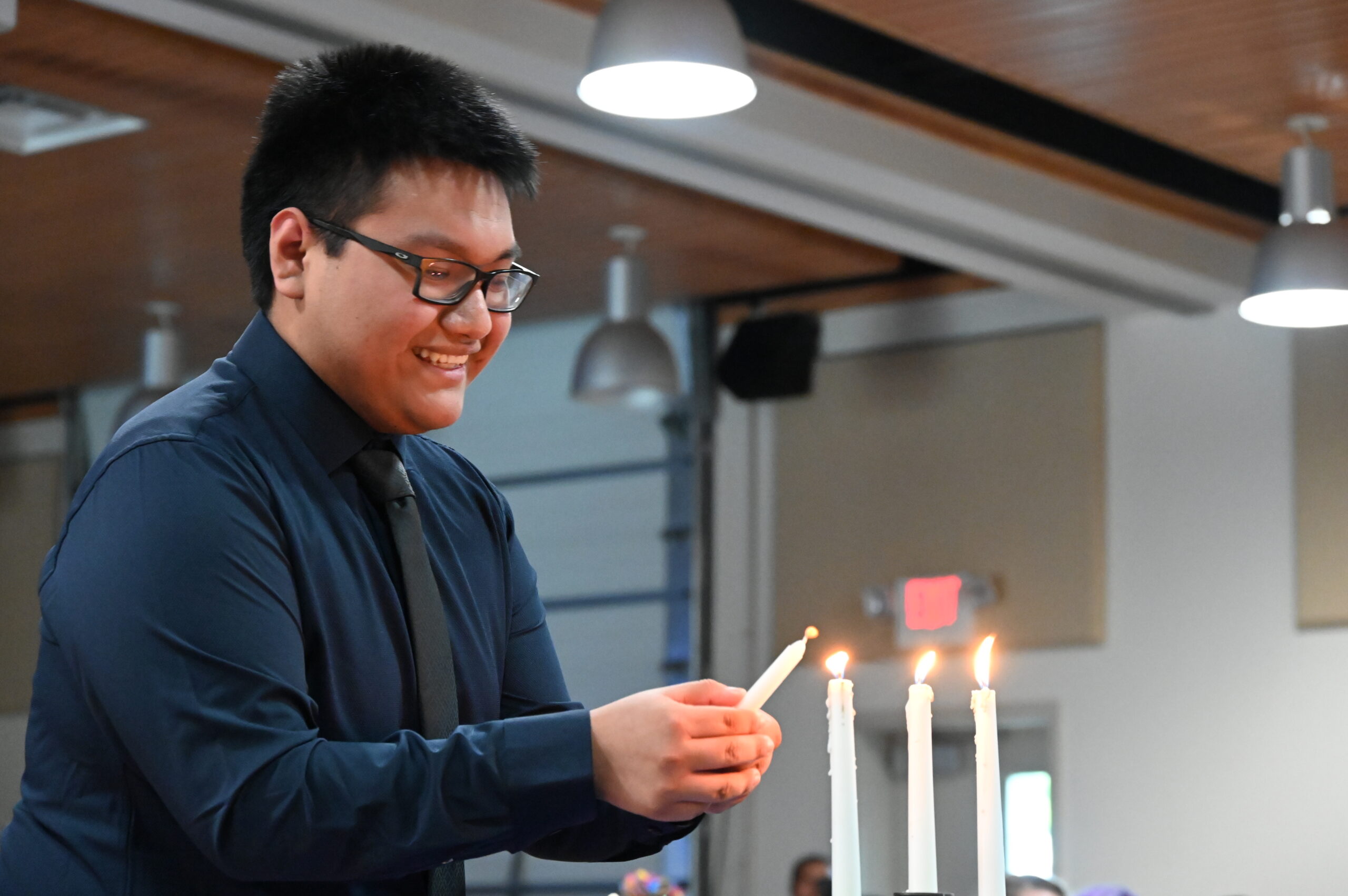 A student lighting a candle.
